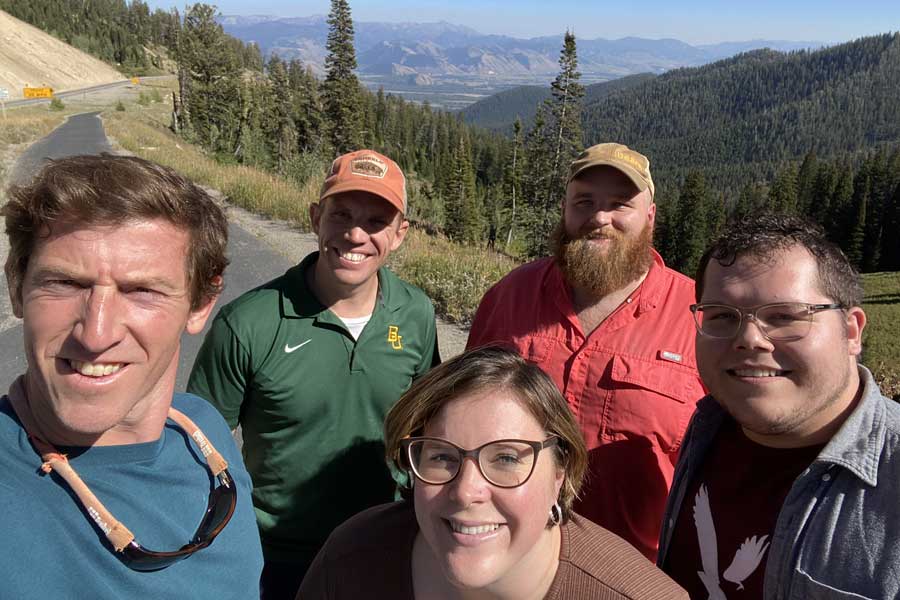 Ryan McManamay, Ben Ryan, Jillian Sturtevant, Jordan Jatko and Josh Beard standing at overlook at Teton Pass between Victor, ID, and Jackson Hole, WY.