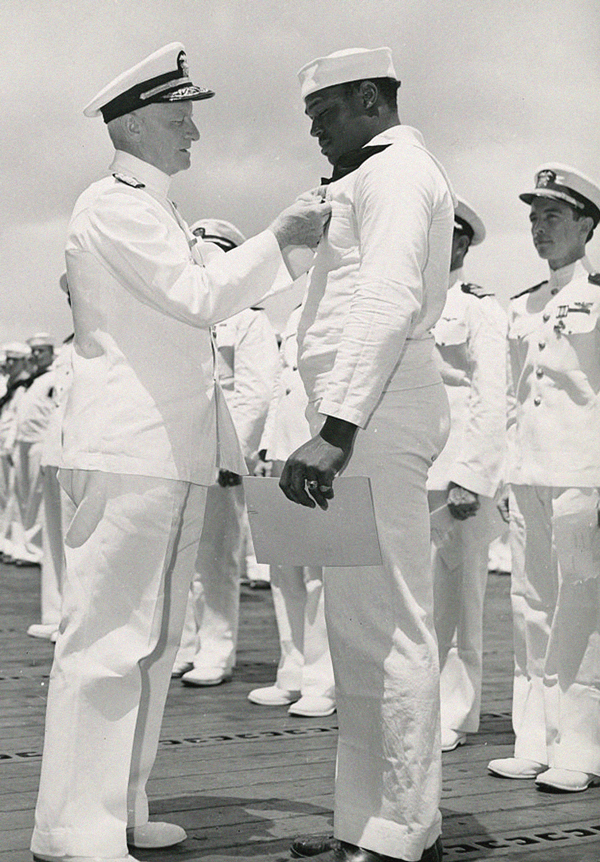 Miller is awarded the Navy Cross by Admiral Chester W. Nimitz, Commander in Chief of the Pacific Fleet