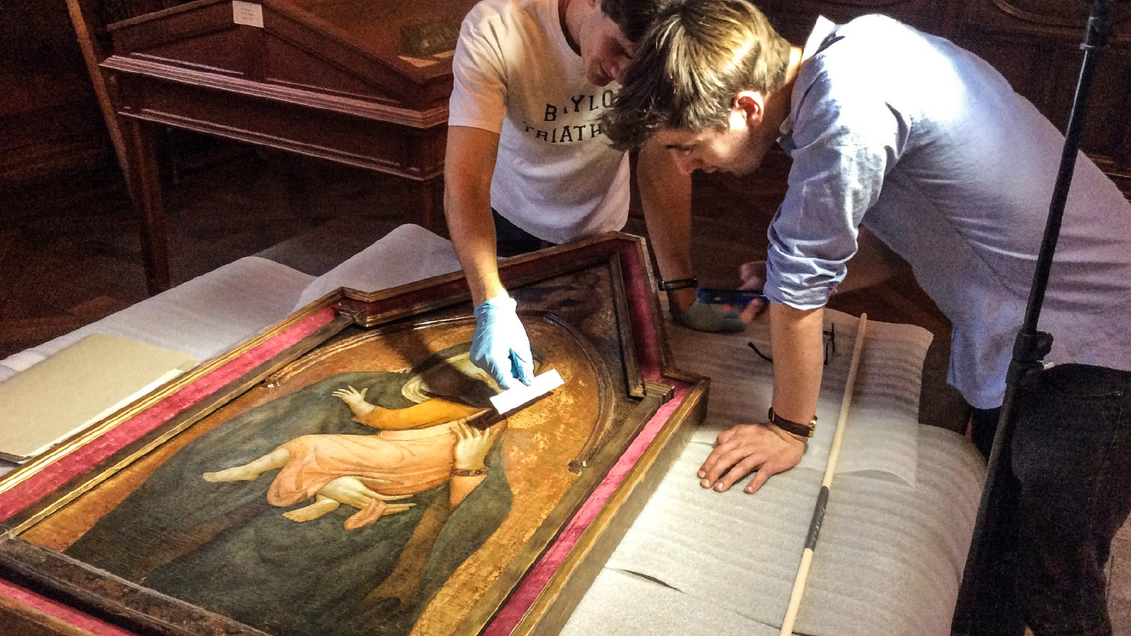 Two University Scholars (Nathan Eberlein, BA '17 and Conner Moncrief, BA '16) examine a 14th-century Madonna and Child painted by a follower of the Sienese artist Pietro Lorenzetti in the Armstrong Browning Library