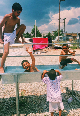 Children find ways to have fun in one of the refugee camps in Greece.