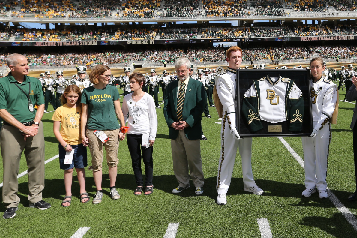 At Homecoming 2016, BUGWB presented the Grotberg family with a framed shadow box of David’s uniform, dedicated their performance to David, and wore green, gold and black ribbons with “In Loving Memory of David Grotberg.”