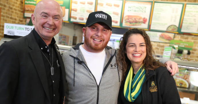 Mark Ochsenbein, Nick Harrington and Jessica Alford celebrate after Soldier's Wish surprised Harrington with a $5,000 gift.