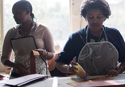 Women in Addis Ababa, Ethiopia cut, sew, stamp 