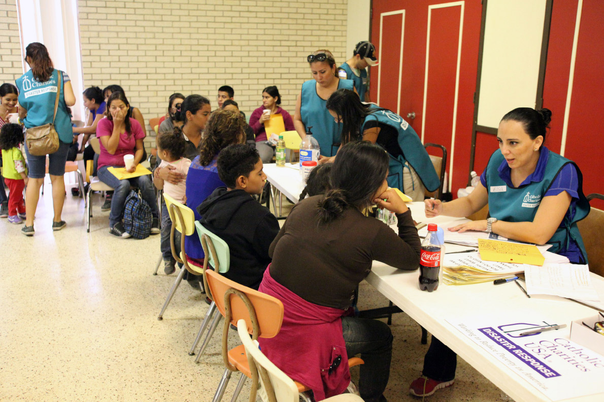 disaster_response_team_talks_with_a_central_american_refugee_at_the_intake_and_orientation_table