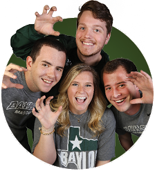Group photo of four students doing a Sic Em
