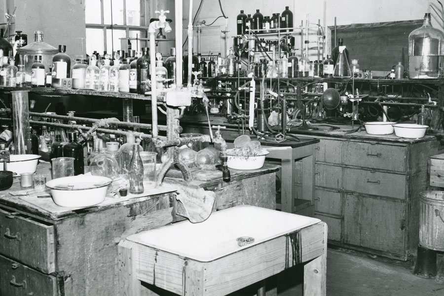 Historic black-and-white photo of an early Baylor chemistry lab filled with glassware.