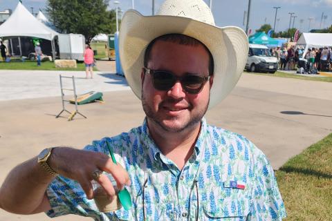 Concertgoer at Boys from Oklahoma concert enjoys Dr Pepper Hour Tour floats