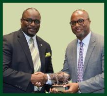 Dr. Michael McFrazier (L) receiving award presented by Larry Coffer, II, B.S.E. ’00, M.S.E. ’06 (R).