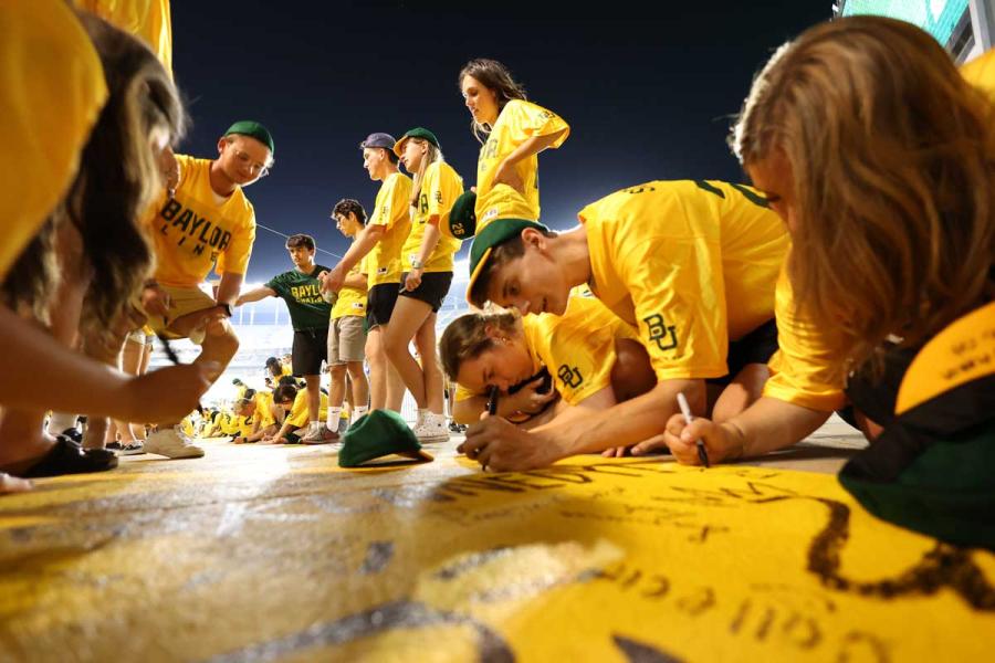 Students signing end zone at McLane stadium 