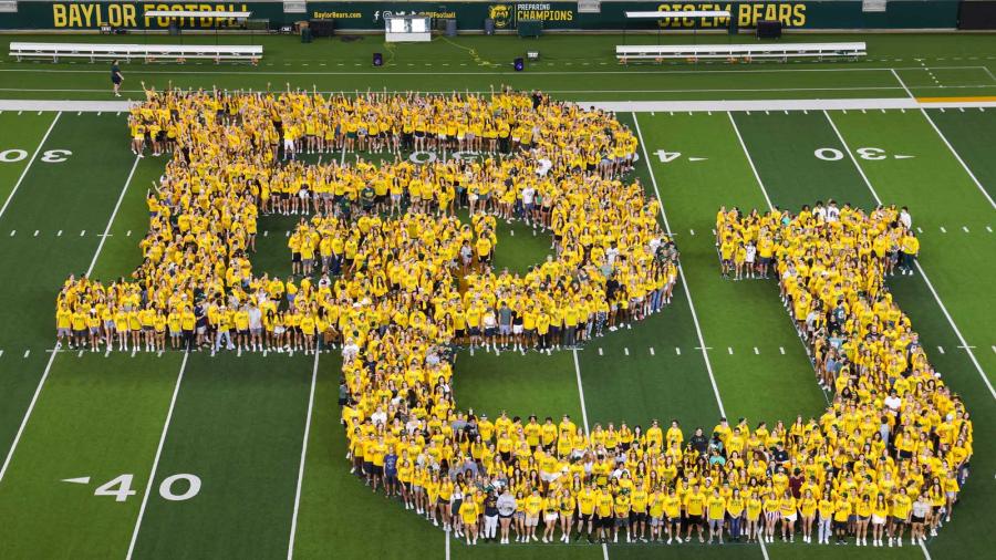 students spelling out BU on football field at McLane stadium 