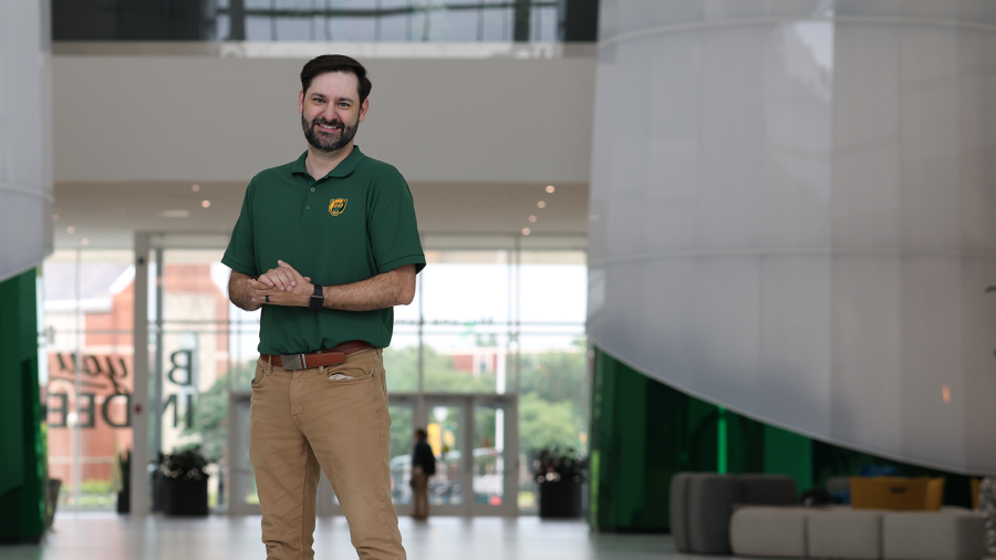 Baylor esports head coach Adam Stanley stands in the Hurd Welcome Center hall