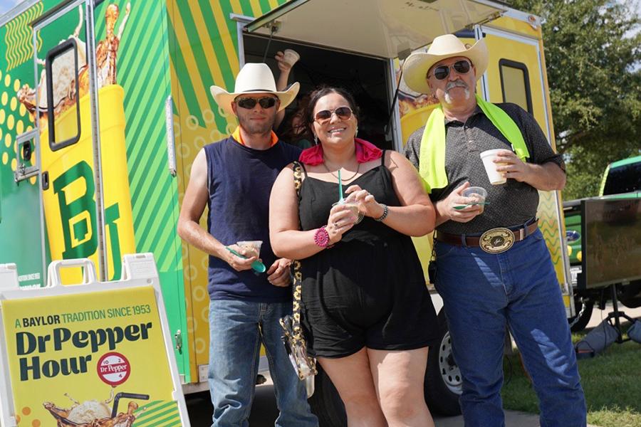 Concertgoers at the Boys from Oklahoma concert enjoy the Dr Pepper Hour Tour's floats at McLane Stadium