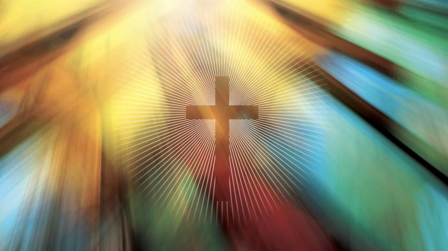 Cross emblem in front of stained glass
