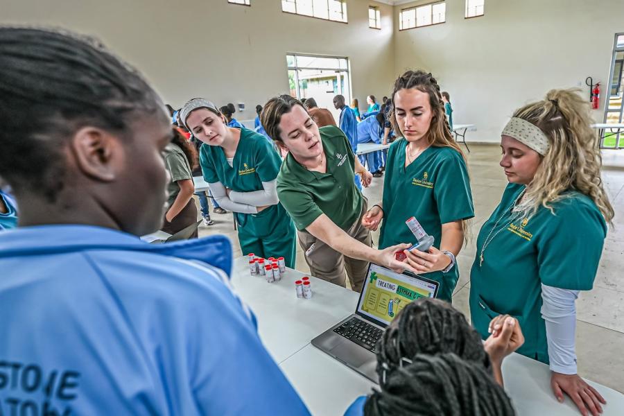 Nursing professor Katy Vogelaar serves alonside students on missions trip to Kenya.
